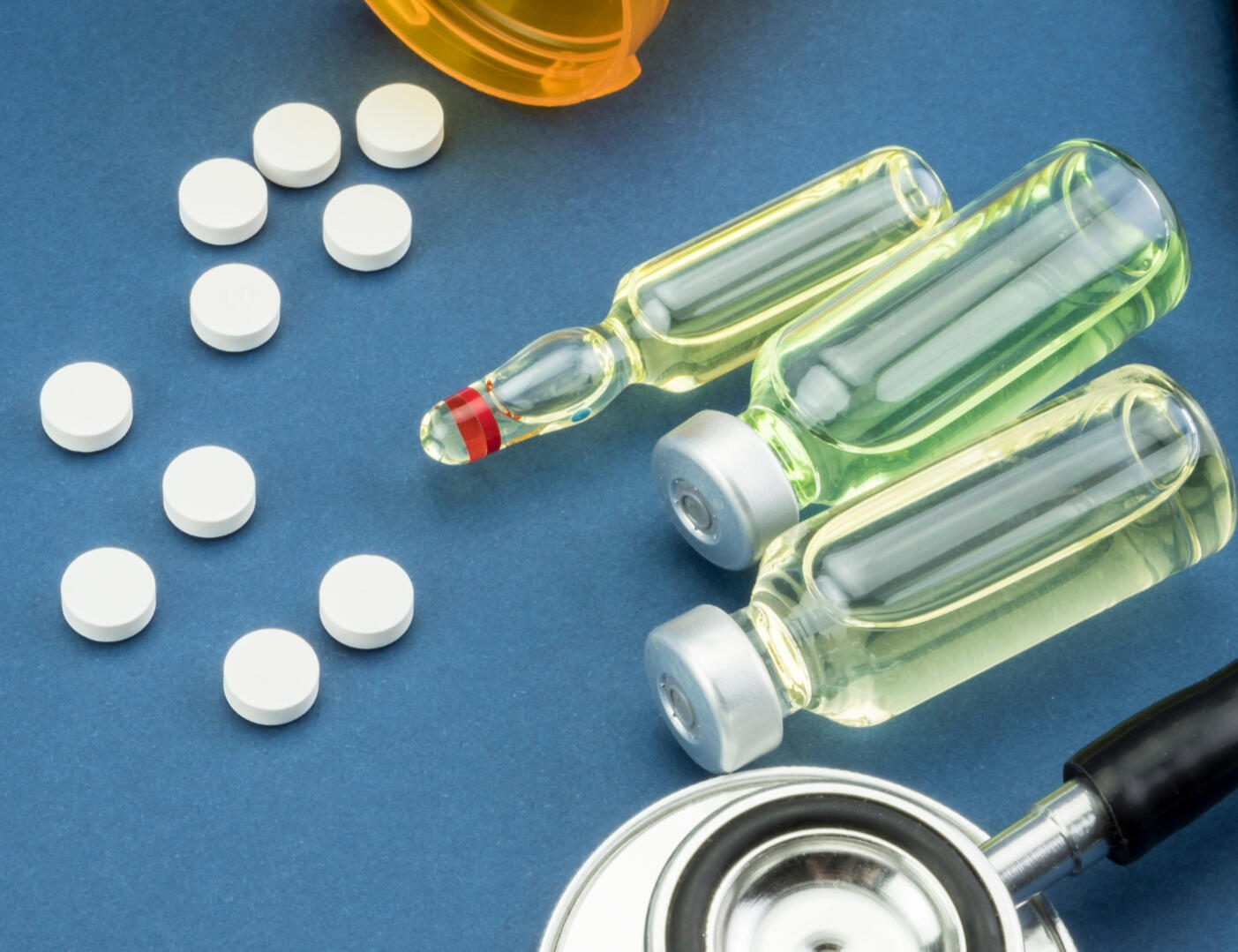 Tablets, ampoules and vials beside a stethoscope